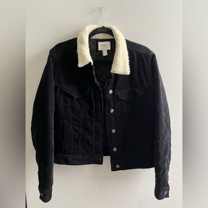 A black corduroy jacket featuring faux shearling lining.